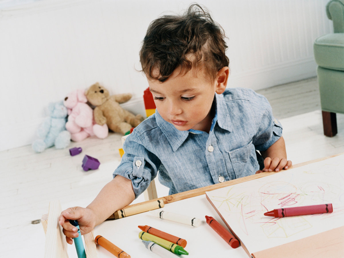 A child drawing during a Kuddles activity