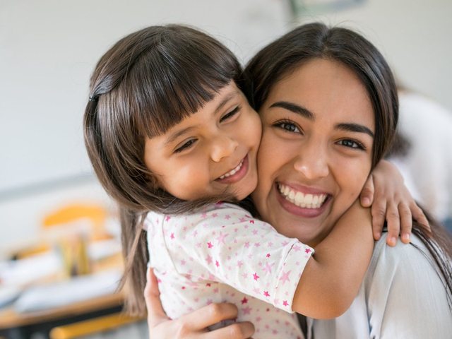 A Kuddles educator sharing a warm moment with a child