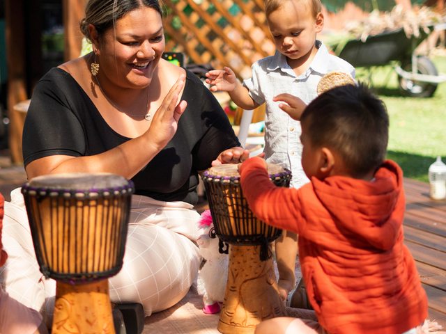 A qualified Kuddles educator leading a music activity