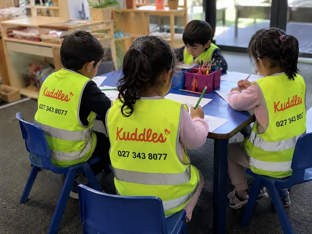 Children drawing together at a Kuddles learning table